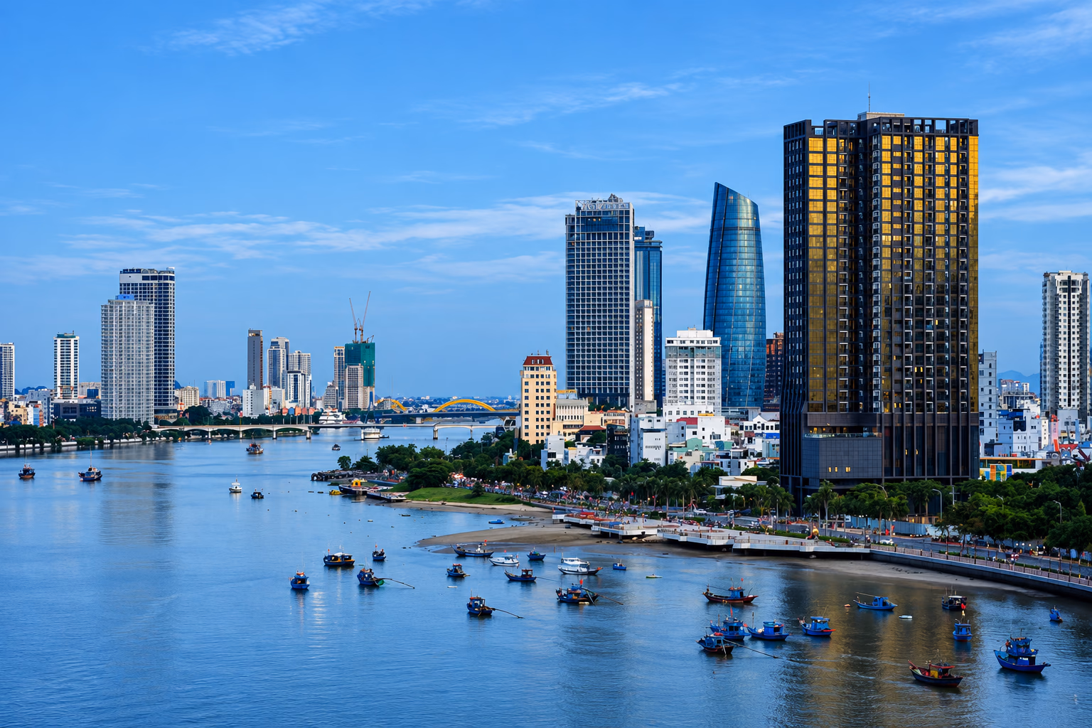 A river lined with high-rise towers and blue fishing boats at dusk