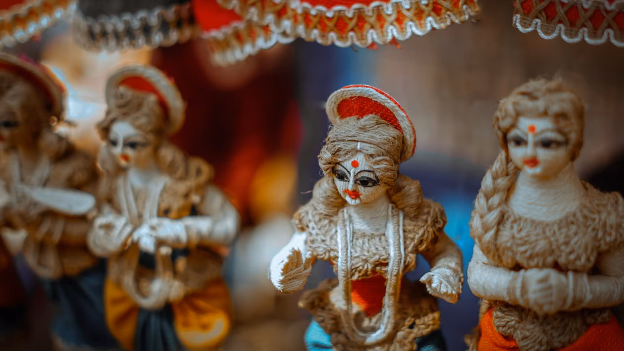 Painted figurines of seated deities in a craft shop