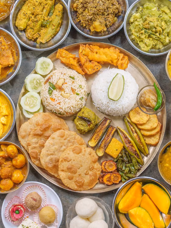 A thali of curries, rice and breads seen from above
