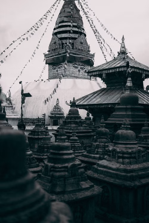 Prayer flags strung above the spires of a Nepali stupa