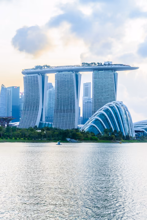 Marina Bay Sands towers beside the domed Gardens by the Bay conservatories