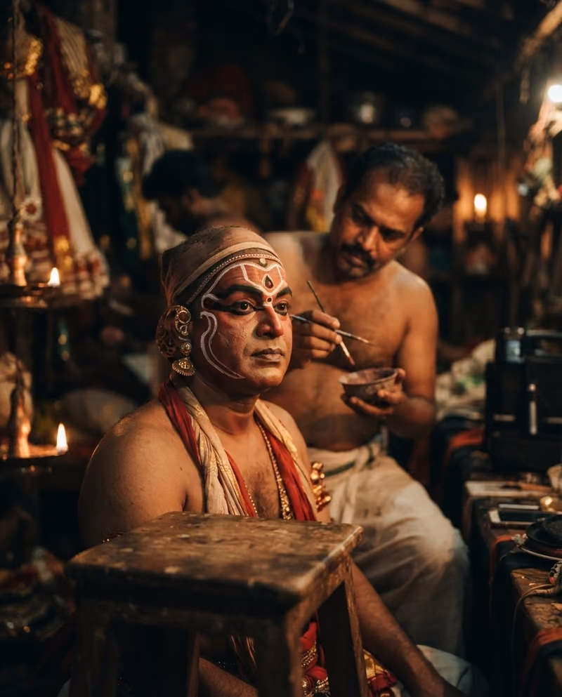 A Kathakali performer having traditional face paint applied by candlelight
