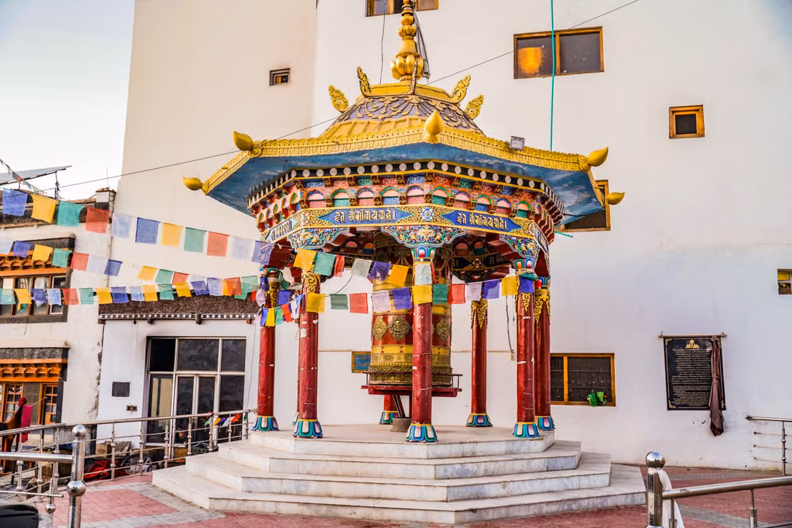 A gold-roofed prayer pavilion hung with prayer flags