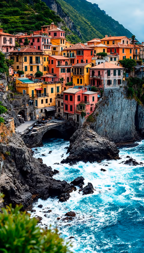 Pastel-hued cliffside houses above a rocky Cinque Terre cove