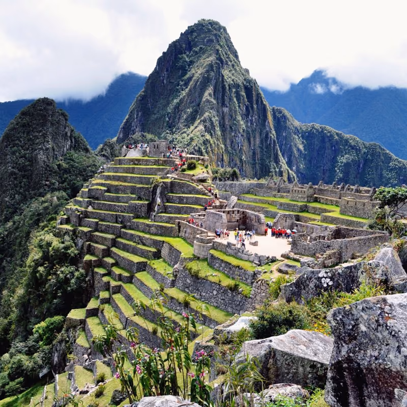 Inca stone terraces and ruins beneath the Machu Picchu peaks
