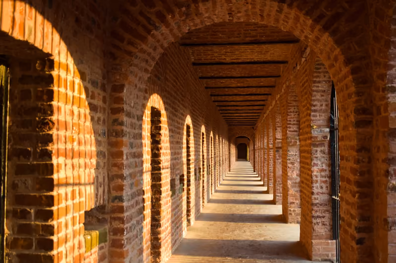 A long brick arcade at Cellular Jail receding into the distance