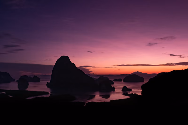 Rocks silhouetted against a purple Andaman sunset