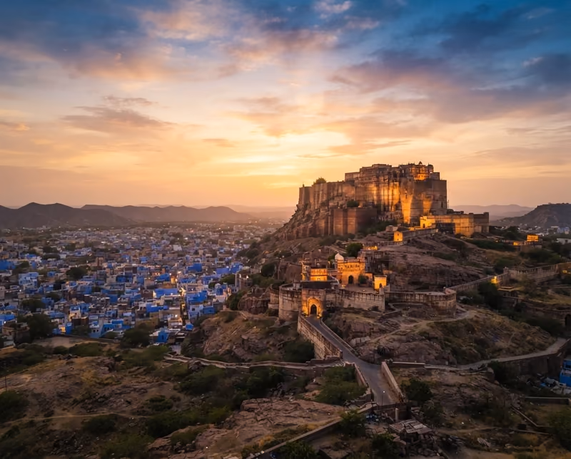 Mehrangarh Fort rising over the blue rooftops of Jodhpur at sunset