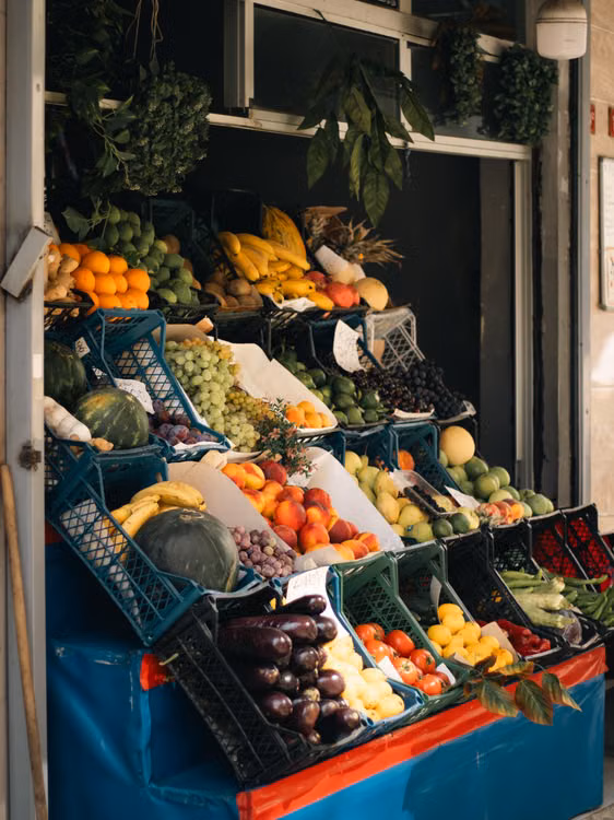 A fruit and vegetable stall piled with produce